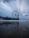 Blue hour beach water reflection panorama of sky view ferris wheel on pier of Scheveningen The Hague Netherlands Europe Royalty Free Stock Photo