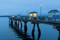 Blue hour morning on the Edmonds Fishing Pier with warm glow of lights