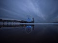 Blue hour panorama of lit illuminated sky view ferris wheel on beach pier of Scheveningen The Hague Netherlands Europe