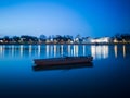 Blue hour on Sava river, promenade in Slavonski Brod and blurred boat in front