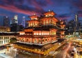 Sunset over Chinatown temple in Singapore decorated for Chinese New Year, with city skyline in background