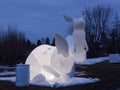 Blue hour view of two glowing giant inflatable rabbits