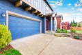 Blue house exterior. View of garage and porch with red entrance door. Royalty Free Stock Photo