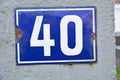 A blue house number plaque, showing the number forty