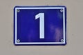 A blue house number plaque, showing the number one Royalty Free Stock Photo