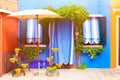 Blue house with and plants. Nice bench near entrance. Colorful house in Burano island near Venice, Italy Royalty Free Stock Photo