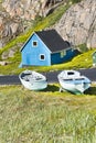 Blue house, wooden boats, Greenland Royalty Free Stock Photo