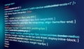 Blue HTML CSS code glowing on dark screen showing web development syntax and programming structure Royalty Free Stock Photo