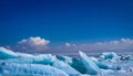 Blue hummocks of ice and frozen lake at Sayram lake