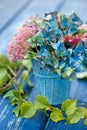 Blue hydrangea blossom with sedum flowers