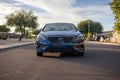 Blue Hyundai Sonata car parked along a residential street on a sunny day