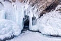 Blue ice cave grotto lake Baikal Olkhon island, Russia. Frozen clear icicles, beautiful winter landscape Royalty Free Stock Photo