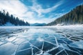 Blue ice and cracks on the surface of the ice. Frozen lake under a blue sky in the winter. The hills of pines. Winter Royalty Free Stock Photo