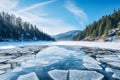 Blue ice and cracks on the surface of the ice. Frozen lake under a blue sky in the winter. The hills of pines. Winter Royalty Free Stock Photo