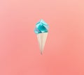 Blue ice cream waffle cone on living coral background