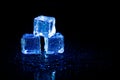 Blue ice cubes reflection on black table background Royalty Free Stock Photo