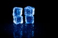 Blue ice cubes reflection on black table background Royalty Free Stock Photo