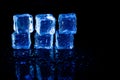 Blue ice cubes reflection on black table background Royalty Free Stock Photo