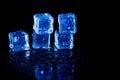 Blue ice cubes reflection on black table background Royalty Free Stock Photo