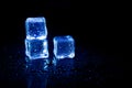 Blue ice cubes reflection on black table background Royalty Free Stock Photo