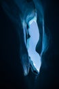 Blue ice of a deep ice cave with wavy walls of the Matanuska Glacier in Alaska Royalty Free Stock Photo