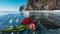 On the blue ice of the frozen Lake Baikal - two glasses of champagne, bright tulips Royalty Free Stock Photo