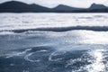 Blue ice with inscription on it and blurred frozen lake