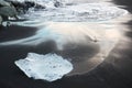 Blue iceberg on the black sand beach, Jokulsarlon lagoon, Iceland