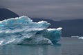 Greenland, blue iceberg with lightblue spots inside of it andwith dramatic mood of the sky in the atlantic ocean Royalty Free Stock Photo