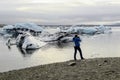 Tourist at Jokulsarlon glacier lagoon in south Iceland