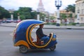 Blue iconic Coco auto rickshaw taxi fast speeding on blurred background of yank tank tanks, Capitol National at Havana, Cuba Royalty Free Stock Photo