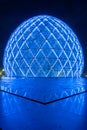 Blue illuminated sphere dome located next to Sheikh Zayed Grand Mosque in Abu Dhabi UAE, shot at night. Royalty Free Stock Photo