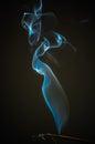 Blue incense smoke on black background Royalty Free Stock Photo