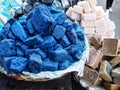 Blue indigo color stones and natural handmade soaps displayed at traditional souk - street market in Marrakech, Morocco, closeup Royalty Free Stock Photo