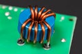 Blue inductor. Magnetic ferrite core detail. Open electric device