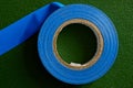Blue industrial insulating tape on a green surface