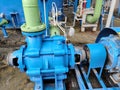 Blue industrial pump with green piping