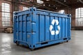 Blue industrial recycling container with a recycle symbol standing on wheels in a large empty warehouse Royalty Free Stock Photo