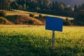 Blue information wooden sign board mockup in scenic alpine meadow in morning