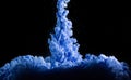 Blue ink in water on dark background. Royalty Free Stock Photo