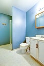 Blue interior of old style bathroom with linoleum flooring