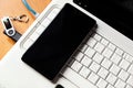 Blue internet cable, flash card and smartphone laying on the white laptop. Royalty Free Stock Photo