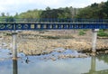 Blue iron bridge construction on it there is a path with two high piles Royalty Free Stock Photo