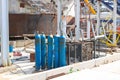 Blue iron metal cylinders with liquefied gas oxygen oxygen air helium argon for welding at the refinery petrochemical plant Royalty Free Stock Photo