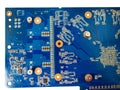 Blue isolated motherboard or computer boar with chips and component on it on a white background Royalty Free Stock Photo