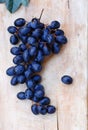 Blue grapes on a wood backdrop