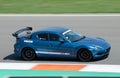 Blue Japanese Mazda RX-8 sports car on a race track