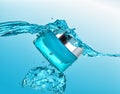 The blue jar of moisturizing cream in the blue water wave with big air bubbles