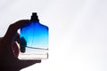 Blue jar of perfume in hand