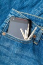 Blue jean pocket with mobile and door key Royalty Free Stock Photo